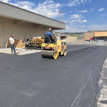 ACME Asphalt crew compacting fresh asphalt on a commercial paving project at Albertsons in Anaconda, MT