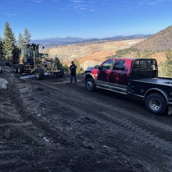 ACME Asphalt crew and equipment preparing a mountain road construction site