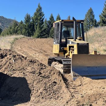 ACME Asphalt loader performing grading and excavation work