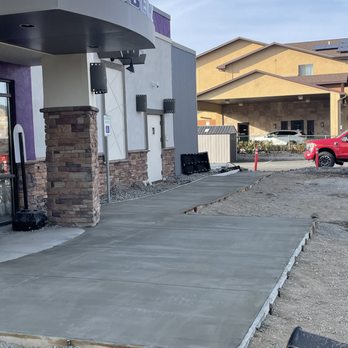 Newly paved commercial driveway and parking area completed by ACME Asphalt at Taco Bell in Butte, MT